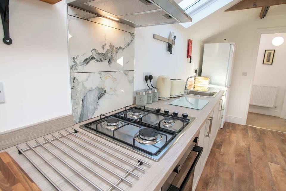 "Whip up your favorite meals in this charming minimalist kitchen—thoughtfully designed with sleek essentials and a warm, welcoming vibe."