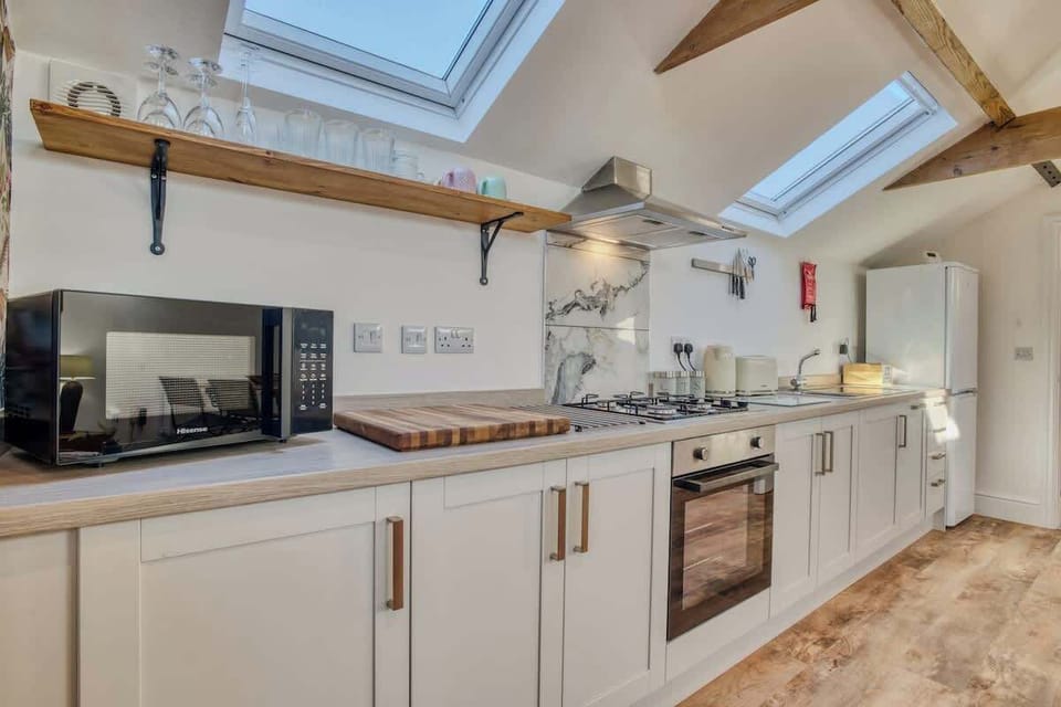 "Whip up your favorite meals in this charming minimalist kitchen—thoughtfully designed with sleek essentials and a warm, welcoming vibe."
