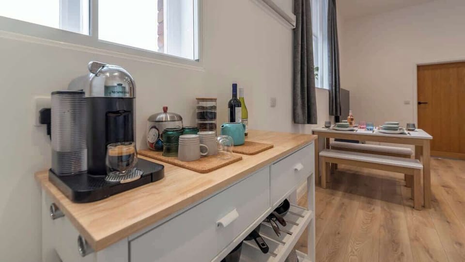 Bright and spotless — a clean kitchen paired with a charming coffee nook, perfect for morning brews and effortless meal prep.
