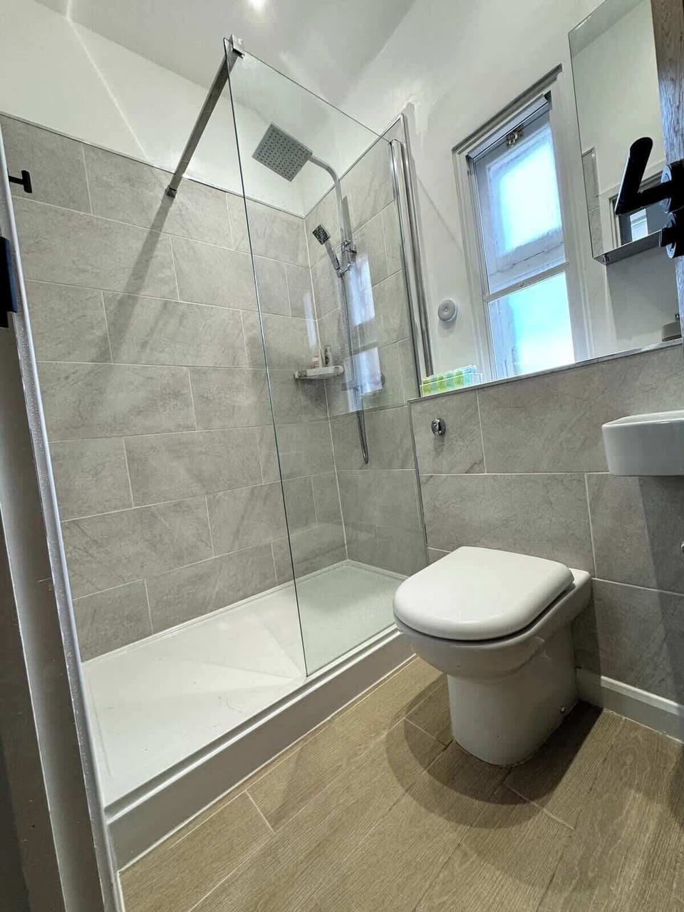 Complete comfort — a full bathroom featuring a shower, toilet, wash basin, and bathtub for a refreshing and relaxing experience.