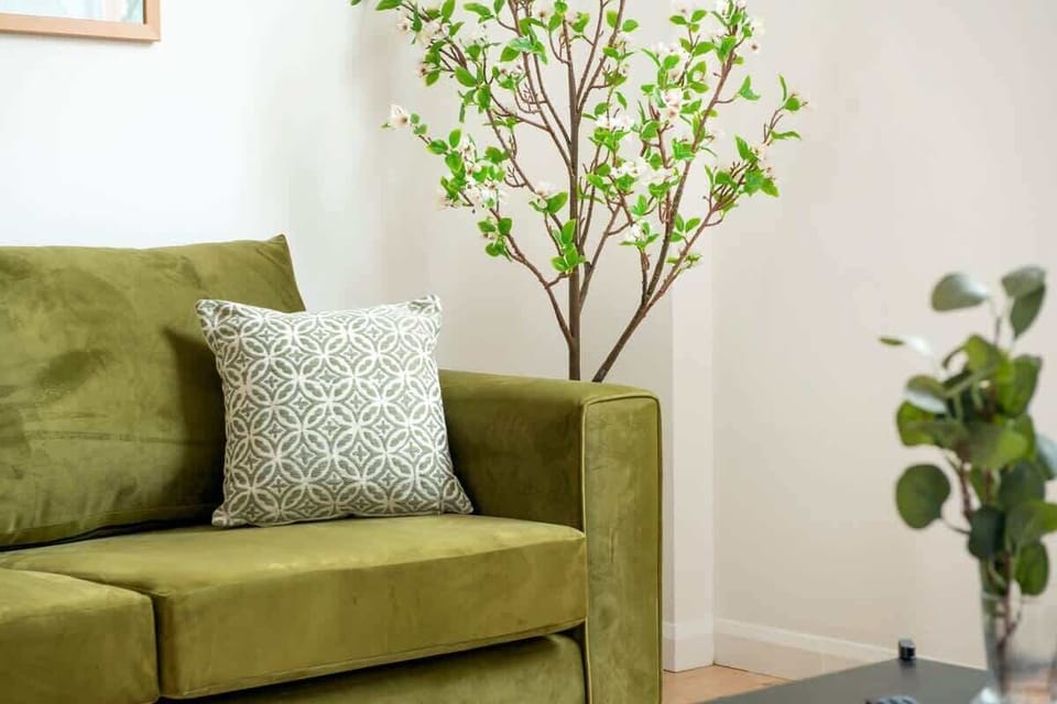 "Relax in style in our beautiful living room, featuring a cozy sofa that easily transforms into a comfy sofa bed for extra sleeping space."