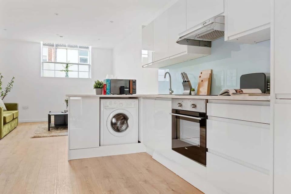 "A small yet sleek and minimalist kitchen, designed for both efficiency and style—perfect for preparing meals in a modern, clutter-free space."