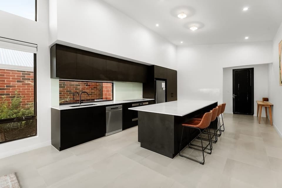 Prepare local produce in a sleek contemporary kitchen, where expansive bench space, modern appliances and garden outlooks make cooking feel effortless and enjoyable.