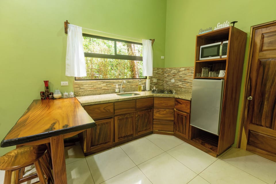 Full-size fridge, microwave, stovetop, cookware/dishes/utensils