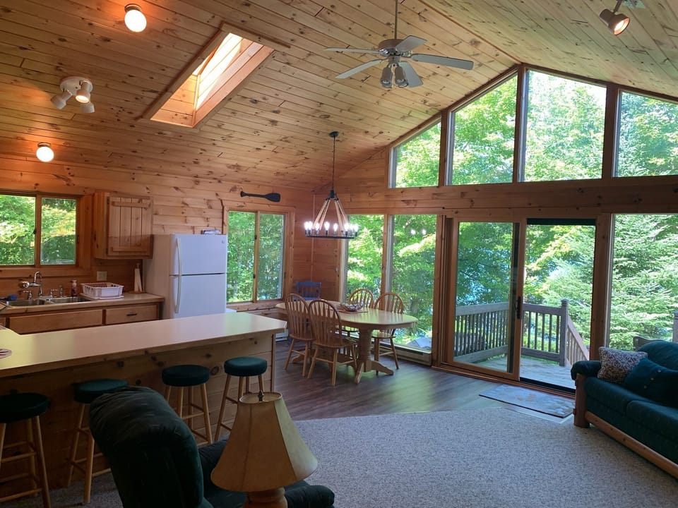 Large windows overlooking the firepit and lake 