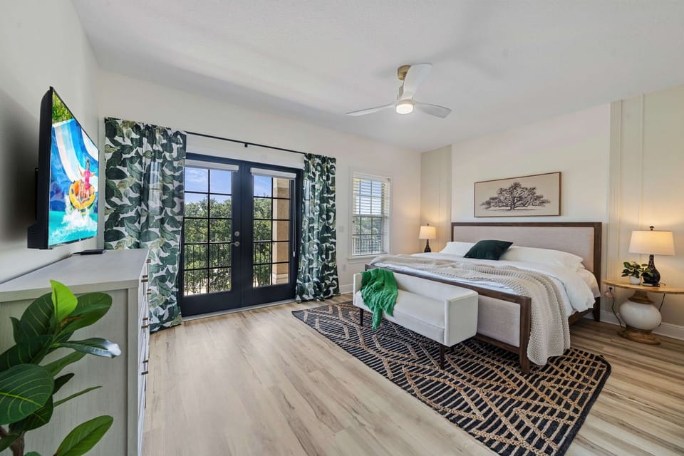 Additional bedroom with cozy bedding, ceiling fan, and elegant décor—ideal for guests seeking comfort and privacy.