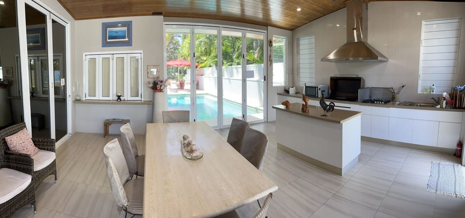 Dining area overlooking private use pool