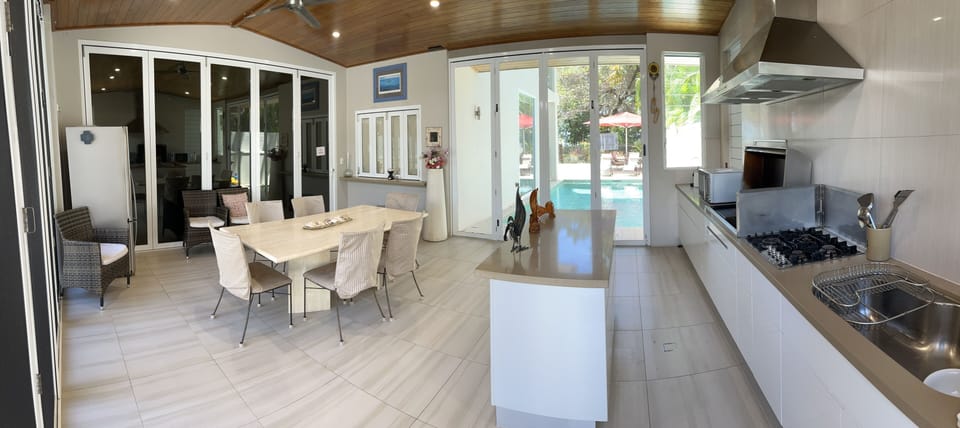 Spacious kitchen and dining area overlooking the pool and courtyard