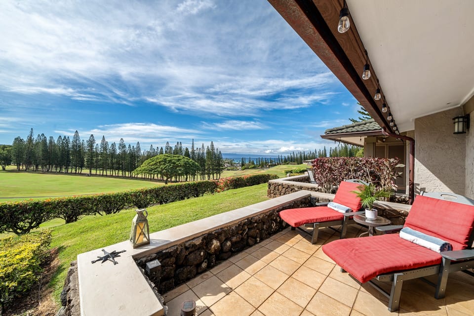 Relax on comfortable red loungers on the lanai, enjoying stunning views of the lush golf course and ocean.