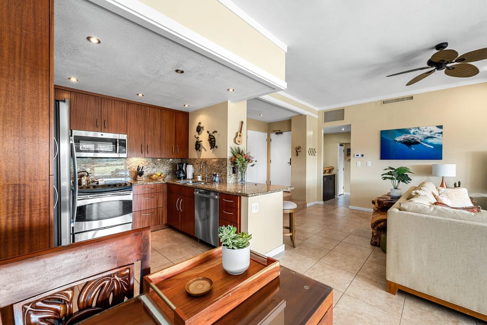 A fully equipped kitchen with sleek appliances and granite countertops, perfect for preparing meals and making the most of your vacation experience.