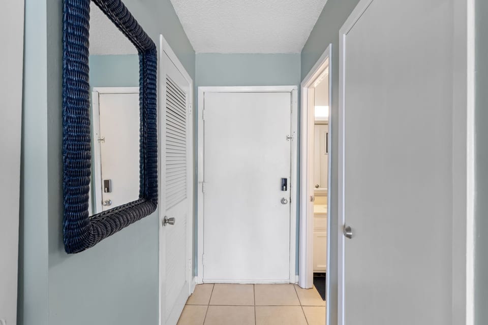 Your private hallway welcomes you with calming coastal colors and thoughtful touches, connecting your bedroom and bathroom spaces seamlessly.