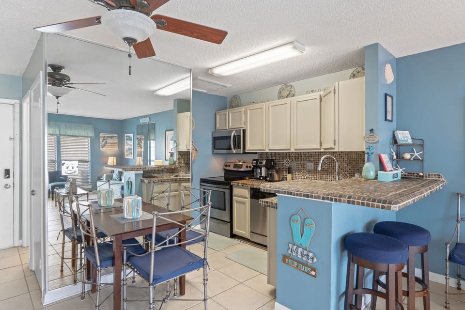 Your bright beach-themed kitchen invites you to create memorable meals with granite countertops, modern appliances, and coastal charm throughout.