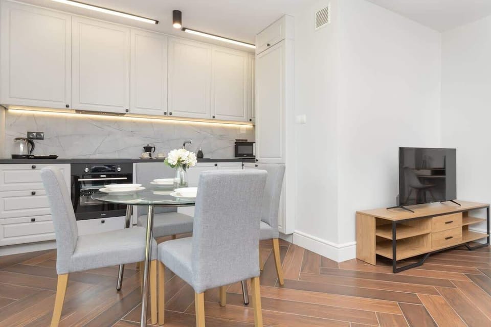 Dining Area & Kitchen – Elegant dining table with chairs, integrated into a modern kitchen.

