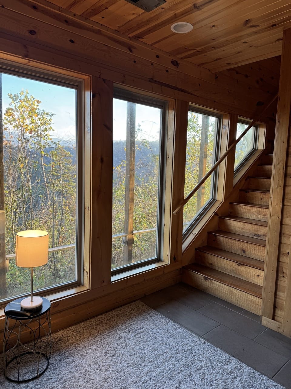 Bottom bedroom does not have a door at the base of the stairs or shades on the windows but has privacy from the forest