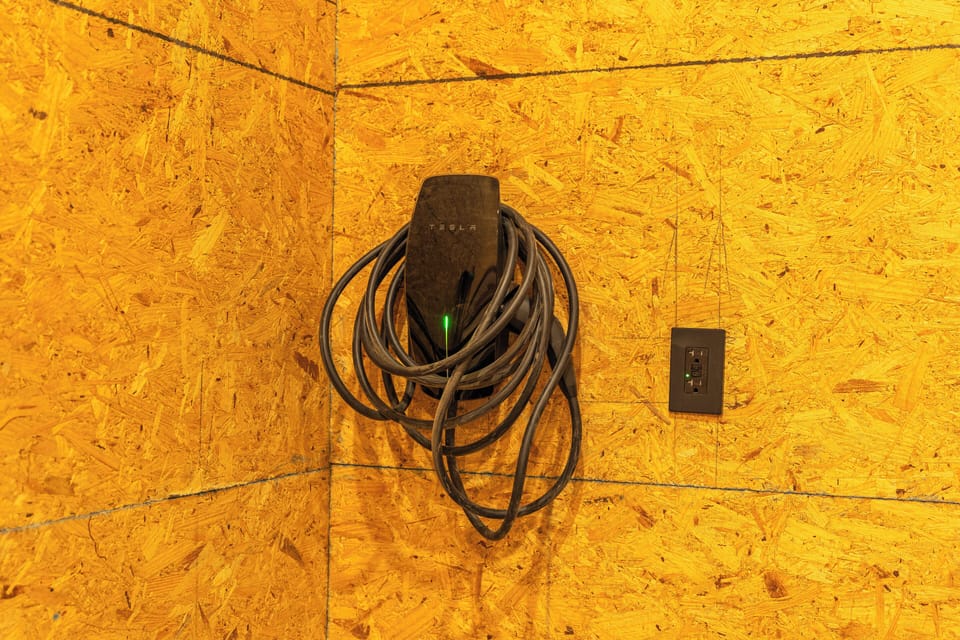 Tesla universal electric car charging station is available in the garage