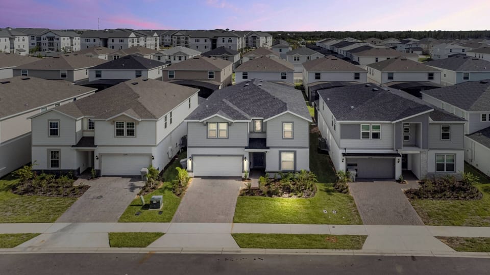 This charming home welcomes you with warm light at the entryway and neat landscaping that enhances its curb appeal, all set in a neighborhood that promises a vibrant community atmosphere for you to enjoy.