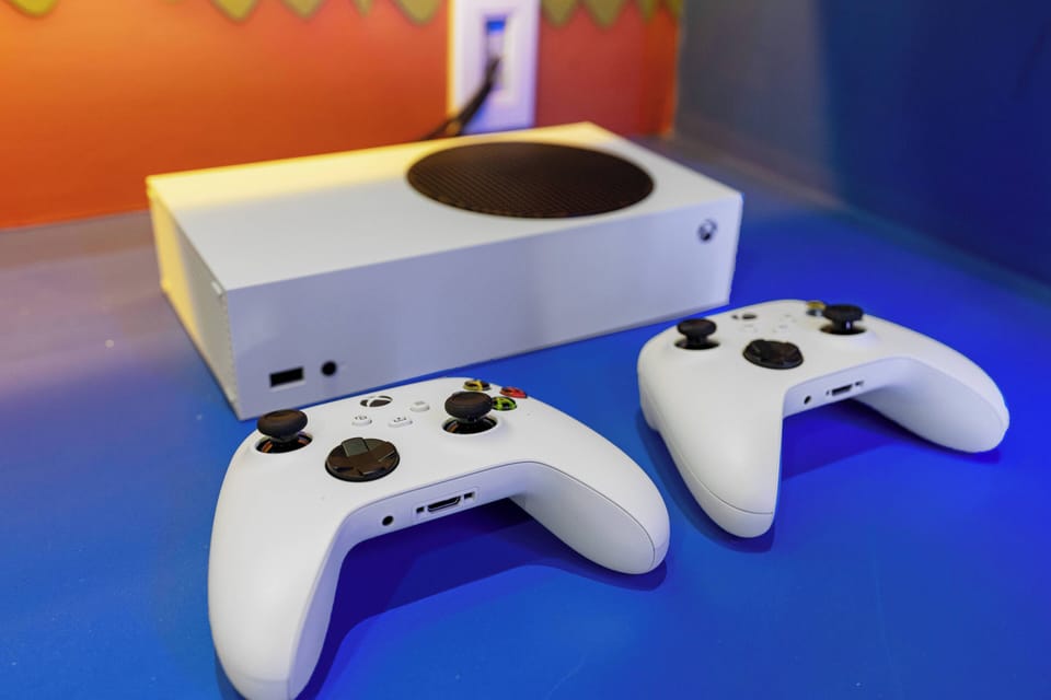 Enjoy a vibrant gaming oasis with a sleek console and matching controllers, perfect for unwinding after a day of adventure. The colorful backdrop creates a playful atmosphere for fun evenings with friends or family.