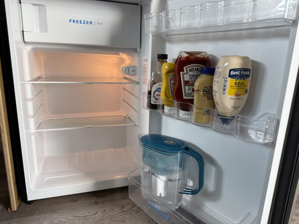 The 4.5 cu ft (127 liter) fridge (with small freezer) has plenty of room for your food. We supply basic condiments like ketchup, mustard, & mayo, as well as a Brita pitcher.