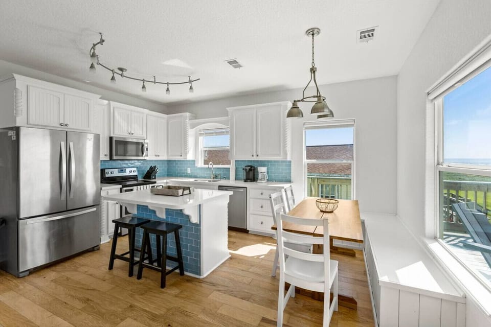 A bright and airy kitchen with modern appliances and ocean views—perfect for cooking and gathering.