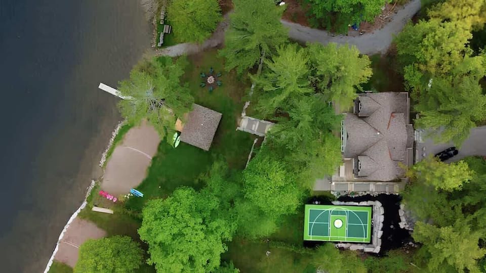 Behold the breathtaking bird's eye view of Greenstone Manor, showcasing its expansive grounds and championship-sized pickleball and badminton court.