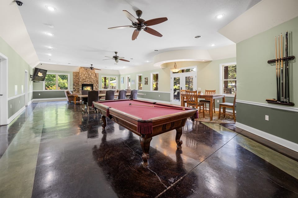 Resort-style clubhouse just steps away, featuring a pool table, fireplace, dining areas, and plenty of space to gather. A great option for rainy days, group hangouts, or extra room without crowding the house.