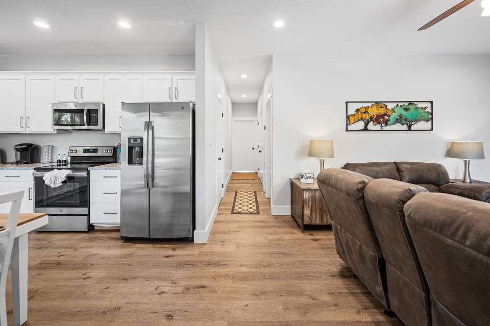 Open living space with full kitchen, dining, and seating all connected—designed so everyone can gather comfortably without feeling cramped. Clean, modern layout makes meals, movie nights, and group time easy and relaxed.