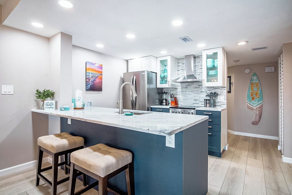 Sleek and modern kitchen with stainless steel appliances and bar seating for two