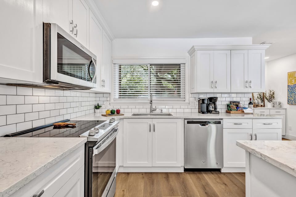 Completely renovated, the kitchen boasts all-new cabinets, countertops, and top-shelf appliances making cooking a truly elevated experience.