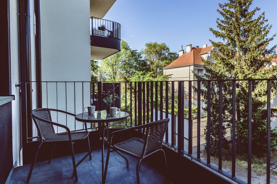 Cozy balcony with a green view – The perfect spot for a morning coffee. A peaceful retreat near Mill Island and the Brda River boulevards.
