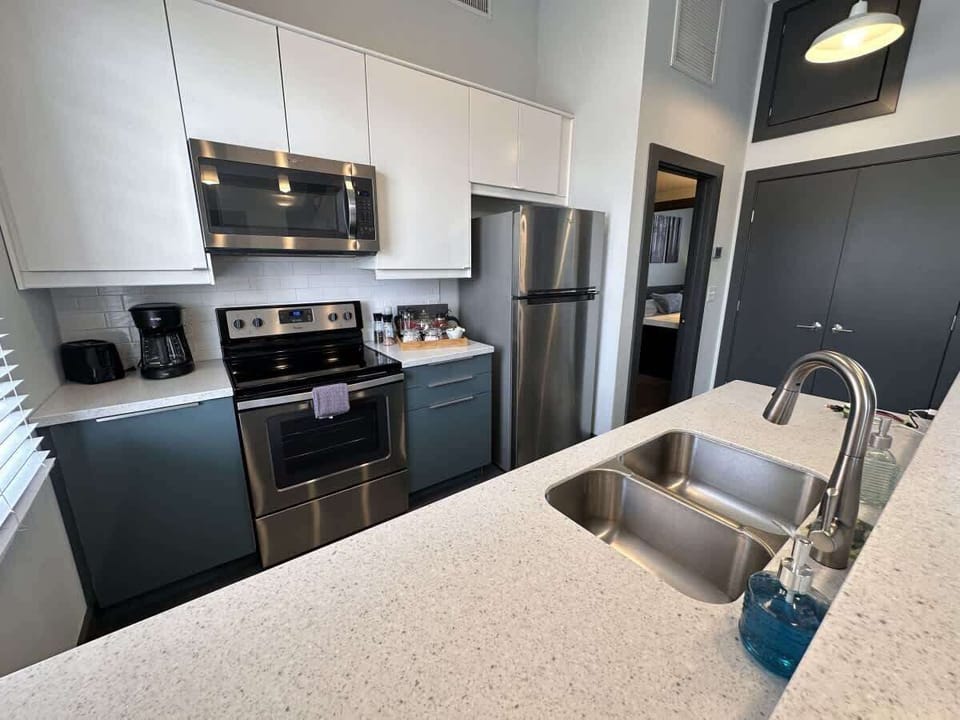 Kitchen with stainless steel appliances and bar seating