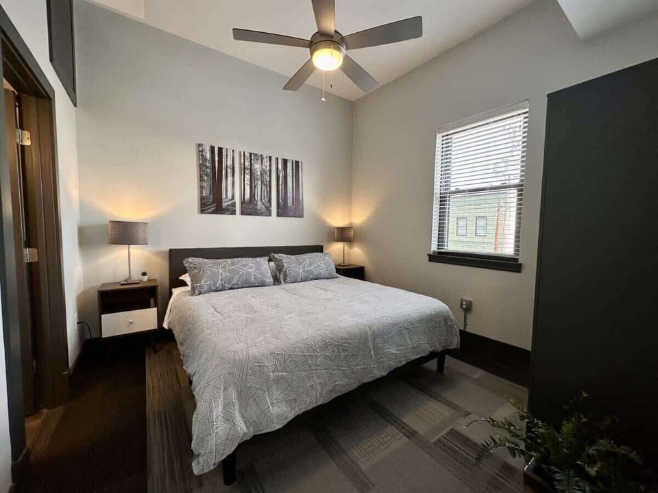 Cozy bedroom with queen bed and ceiling fan