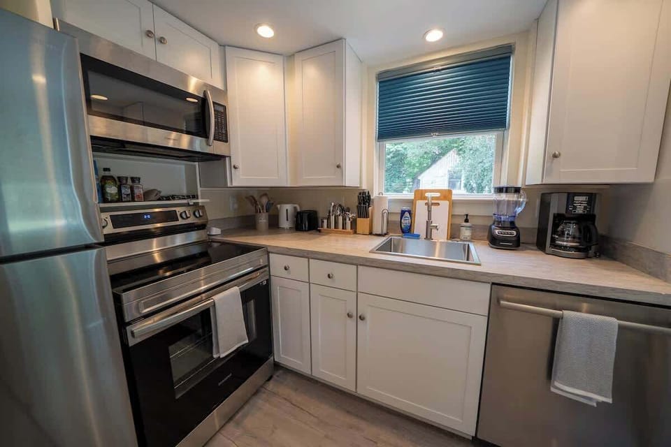 Fully equipped kitchen with sleek countertops and essentials for cooking