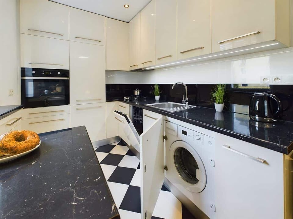 Kitchenette with a washing machine.