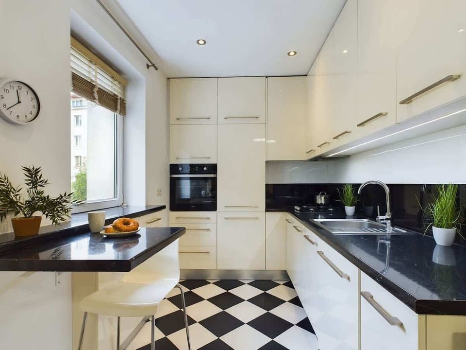 Modern kitchenette with bright cabinets.