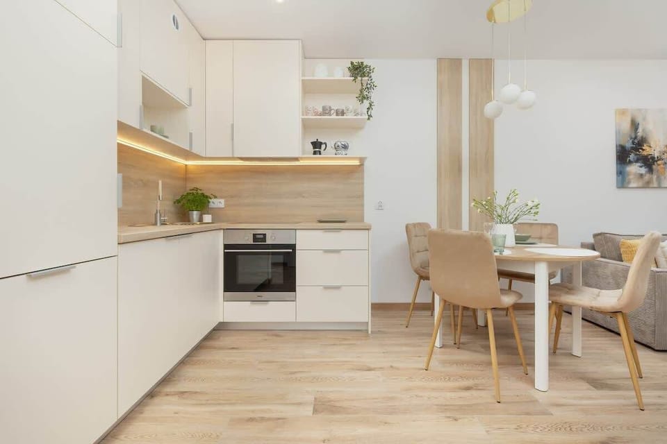 Kitchenette and dining table with chairs.