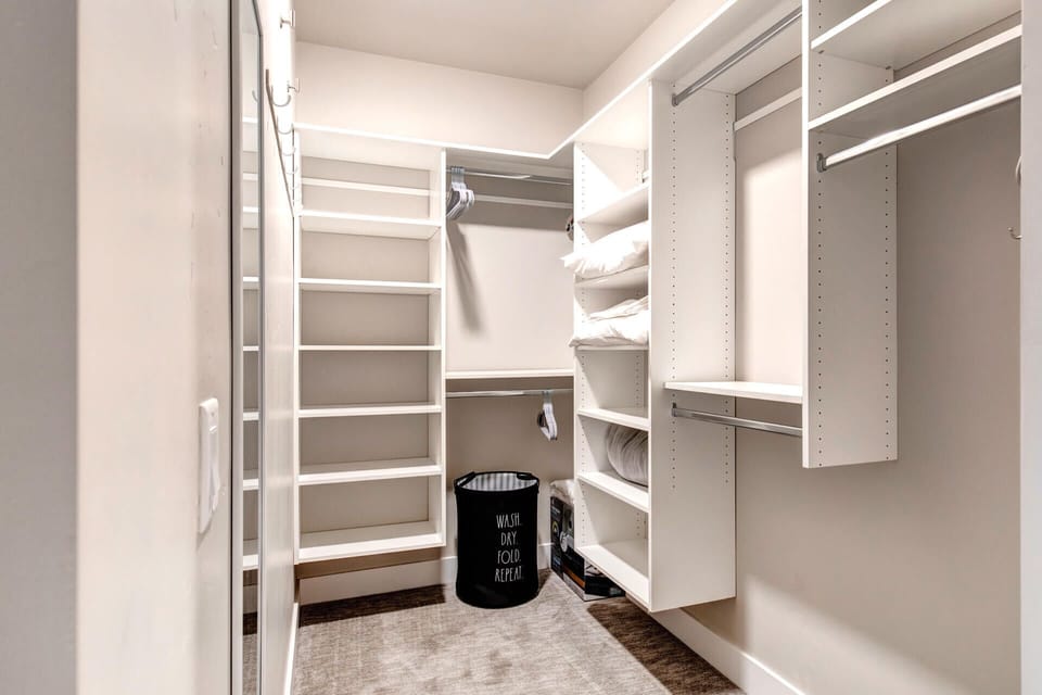 Your walk-in closet awaits with organized shelving, hanging space, and ample room to unpack and feel right at home during your stay.