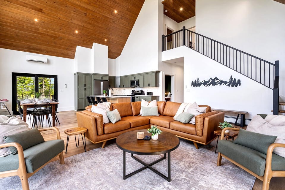Leather sofa & upholstered armchairs, open floorpan, stairs lead to 3rd floor