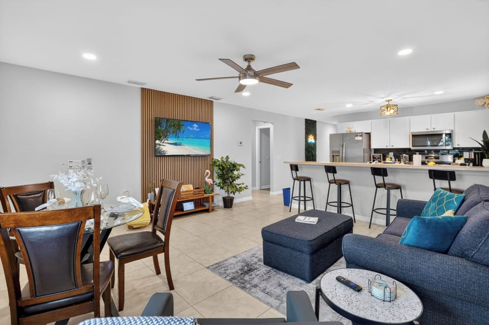 Open living and kitchen area featuring comfortable seating and a flat-screen TV.