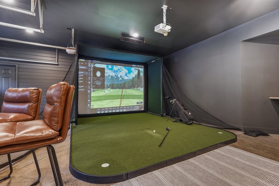 Uneekor Golf Simulator is set up in the garage with plenty of seating and another smart TV. Want to play Pebble Beach?