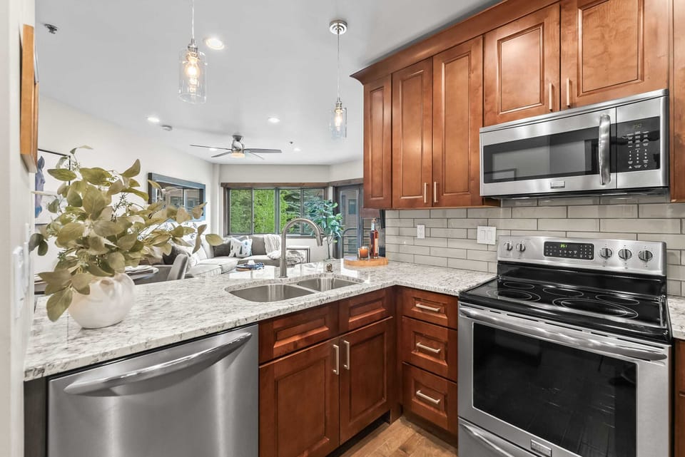 Kitchen: Well-equipped kitchen with new stainless steel appliances, kitchen bar, and 4 bar stools