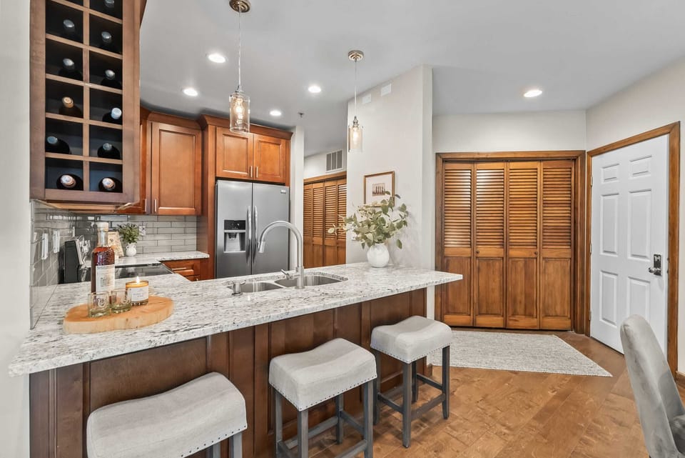 Kitchen: Well-equipped kitchen with new stainless steel appliances, kitchen bar, and 4 bar stools