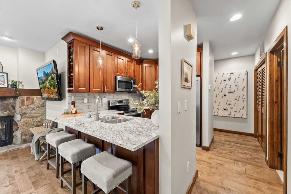Kitchen: Well-equipped kitchen with new stainless steel appliances, kitchen bar, and 4 bar stools