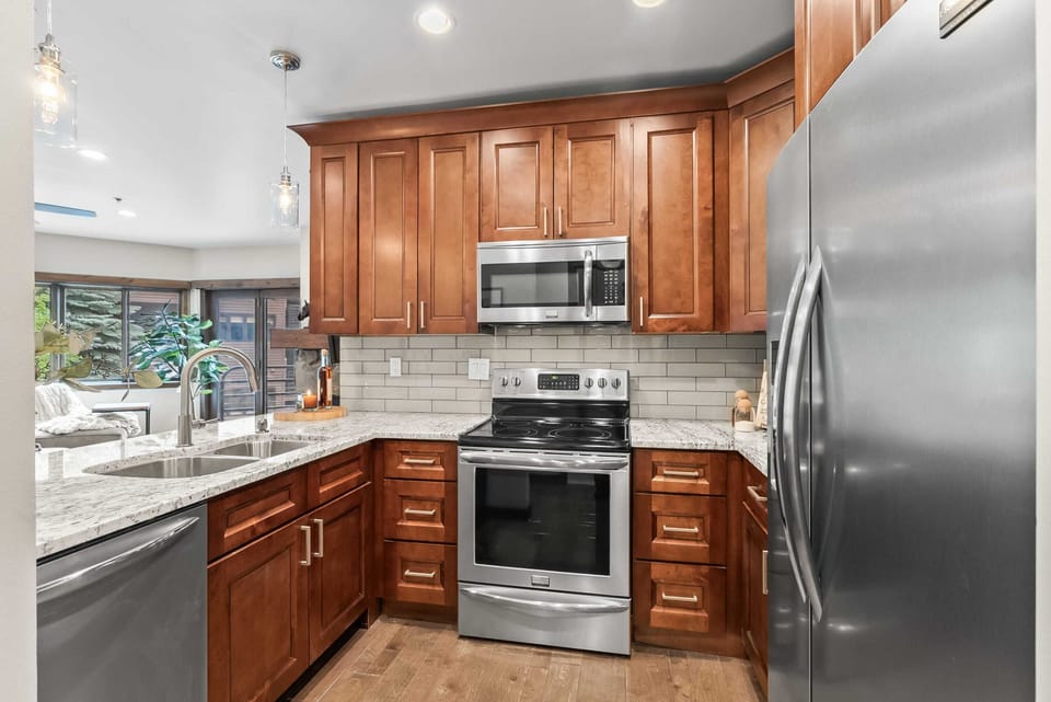 Kitchen: Well-equipped kitchen with new stainless steel appliances, kitchen bar, and 4 bar stools