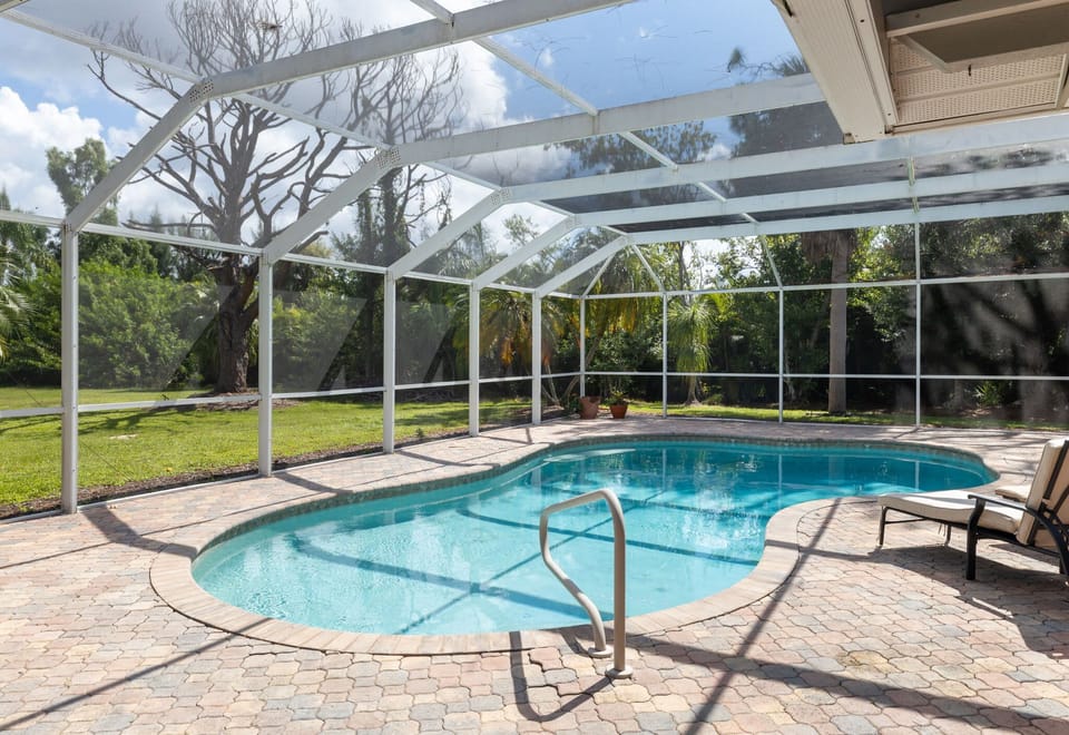 Lagoon style caged pool. Entrance located off of living room.