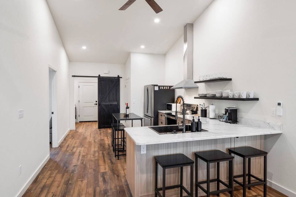 Plenty of seating in the full kitchen with a high top  table and bar seating infront of the sink.  