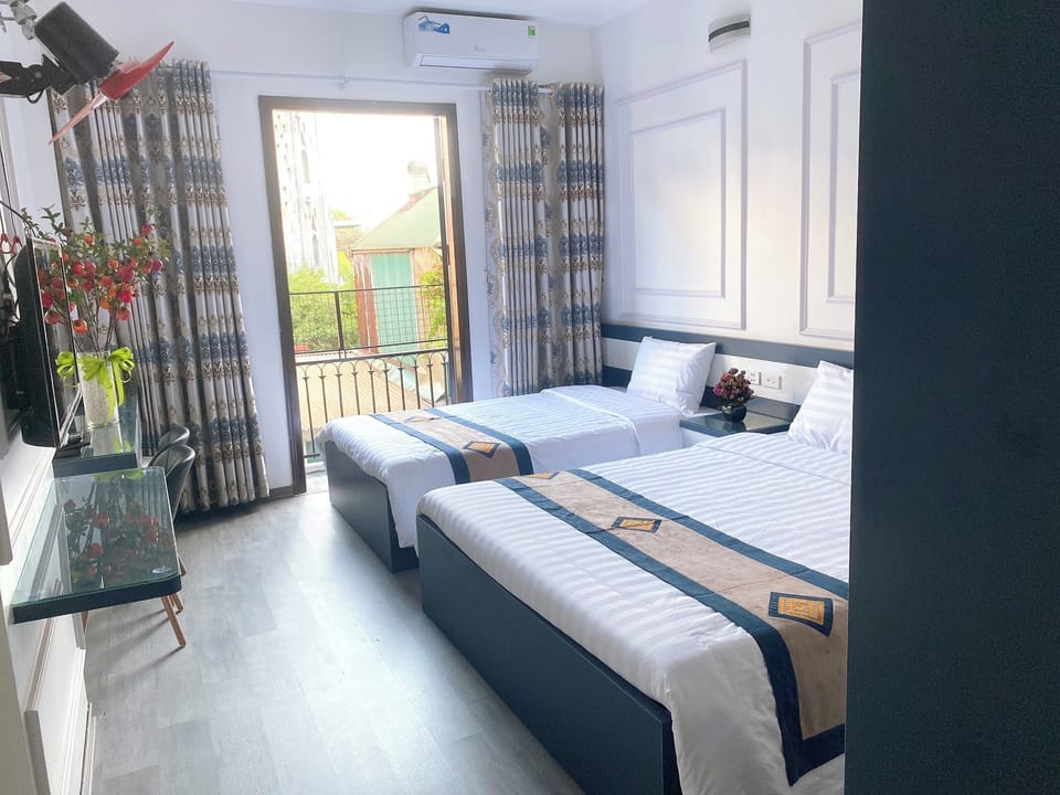 Deluxe Triple Room, City View | Desk, laptop workspace, free WiFi