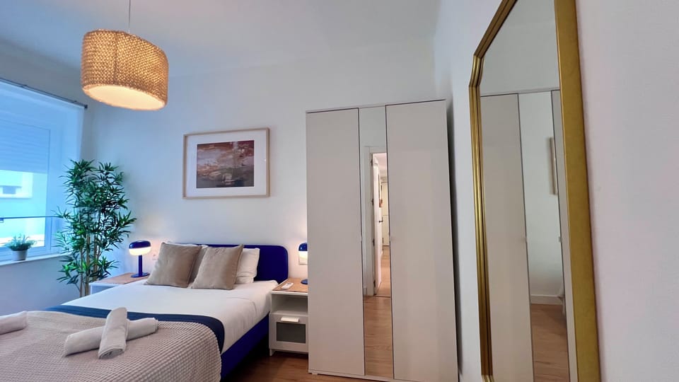 Bright modern bedroom with mirrored wardrobe and cozy designer touches