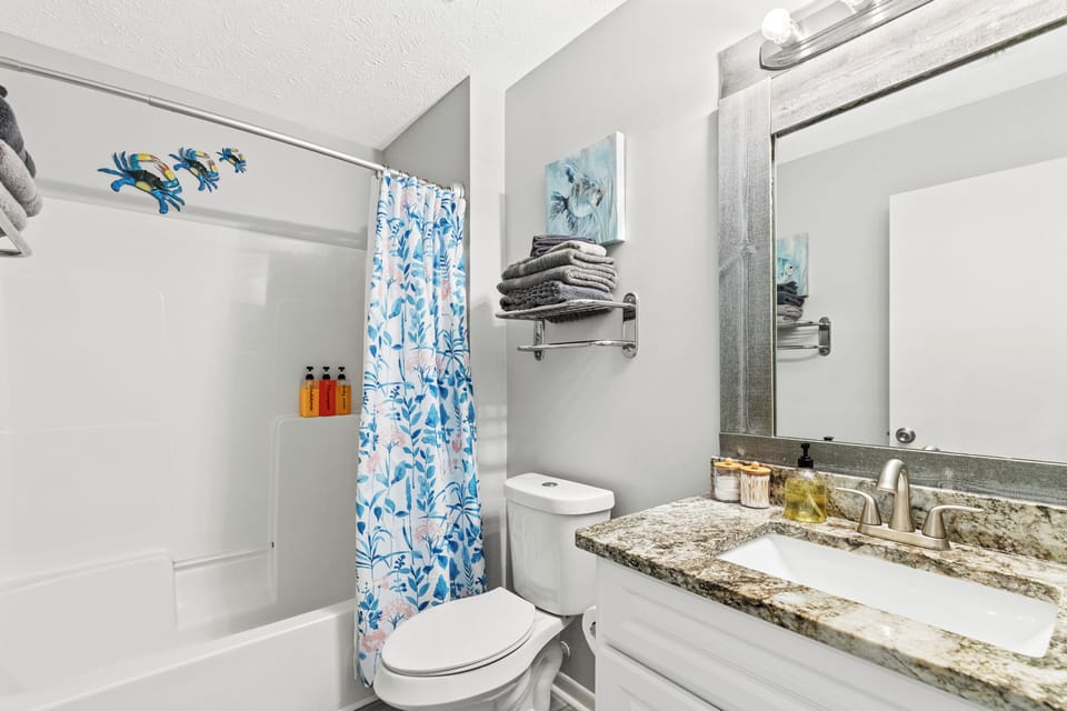 Fully stocked bathroom with towels, shampoo, shower gel, conditioner, and more!