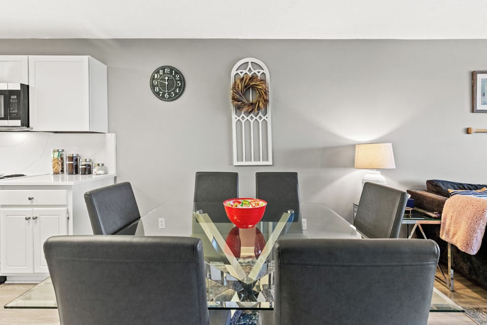 Enjoy meals in the stylish dining space with a modern glass table; seating for 6