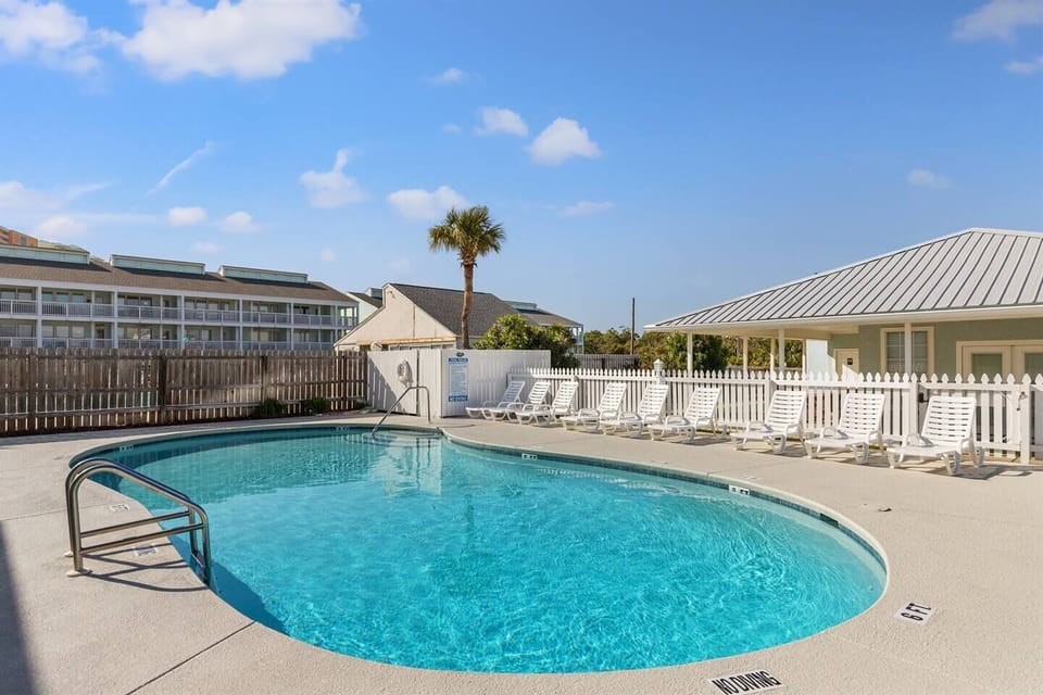 Relax at our community complex outdoor pool, featuring ample lounge chairs and outdoor showers. Dive in, soak up the sun, and refresh in your ultimate vacation retreat. Message for more pool info!